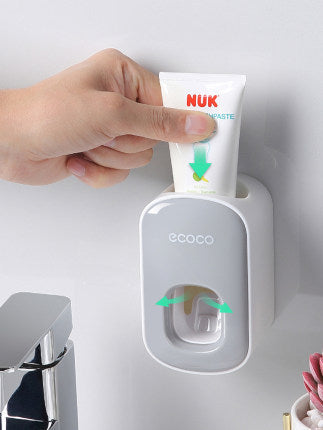 Automatic suction wall squeezing toothpaste artifact